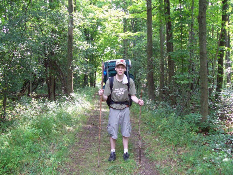 one tall stick, one short stick, with a guy in between